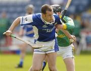 16 May 2004; Robert Jones, Laois, is tackled by Thomas Reilly, Meath. Guinness Leinster Senior Hurling Championship, Laois v Meath, O'Moore Park, Portlaoise, Co Laois. Picture credit; Matt Browne / SPORTSFILE