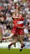 9 May 2004; Colin Holmes, Tyrone, in action against Patsy Bradley, left, and Fergal Doherty, Derry. Bank of Ireland Ulster Senior Football Championship, Tyrone v Derry, St. Tighernach's Park, Clones, Co. Monaghan. Picture credit; Pat Murphy / SPORTSFILE