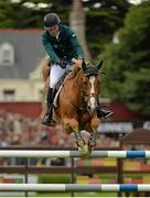 9 August 2013; Conor Swail, Ireland, competing on Lansdowne, on the way to completing a clear round during the Furusiyya FEI Nations Cup. Discover Ireland Dublin Horse Show 2013, RDS, Ballsbridge, Dublin. Picture credit: Barry Cregg / SPORTSFILE