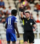 8 July 2022; Junior Quitirna of Waterford is shown a yellow card by referee Mark Moynihan during the SSE Airtricity League First Division match between Waterford and Wexford at RSC in Waterford. Photo by Michael P Ryan/Sportsfile