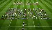9 July 2022; Muslim worshipers join Shaykh Dr Umar Al-Qadri as they offer Eid al-Adha prayers on the pitch in Croke Park during the celebration of Eid Al-Adha at Croke Park in Dublin. Photo by Ray McManus/Sportsfile