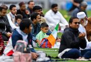 9 July 2022; Muslim worshipers, Milhaan, age six, and his dad Saad Ahmed, join Shaykh Dr Umar Al-Qadri as they offer Eid al-Adha prayers on the pitch in Croke Park during the celebration of Eid Al-Adha at Croke Park in Dublin. Photo by Ray McManus/Sportsfile