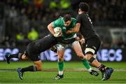9 July 2022; Robbie Henshaw of Ireland is tackled by Aaron Smith, left, and Ardie Savea of New Zealand during the Steinlager Series match between the New Zealand and Ireland at the Forsyth Barr Stadium in Dunedin, New Zealand. Photo by Brendan Moran/Sportsfile