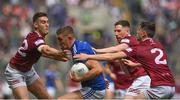 9 July 2022; Killian Clarke of Cavan in action against Westmeath players, from left, Sam Duncan, James Dolan and Jack Smith during the Tailteann Cup Final match between Cavan and Westmeath at Croke Park in Dublin. Photo by Seb Daly/Sportsfile