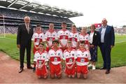 9 July 2022; Uachtarán Chumann Lúthchleas Gael Larry McCarthy, INTO General Secretary John Boyle, and Cumann na mBunscol Chairperson Mairéad O'Callaghan, with the Derry team, back row, left to right, Tomás O’Kane, New Row P.S., Castledawson, Derry, Fionn Brady, Scoil Mhuire, Magherarney, Smithborough, Monaghan, Ruairí Smith, Killygarry N.S., Killygarry, Cavan, Pádraig Donaghy, Blessed Patrick O'Loughran P.S., Castlecaulfield, Dungannon, Tyrone, Fionn Rea, Primate Dixon Coalisland, Coalisland, Tyrone, front row, left to right, Tiarnan Mc Kenna, St Canice P.S., Dungiven, Derry, Ken Irwin, Saint Lorcan's Boy's N.S., Palmerstown, Dublin, Nathan Duffy, Lisdoonan N.S., Carrickmacross, Monaghan, and Thomas Slowey, St Mary's P.S., Newtownbutler, Fermanagh, the INTO Cumann na mBunscol GAA Respect Exhibition Go Games before the GAA Football All-Ireland Senior Championship Semi-Final match between Galway and Derry at Croke Park in Dublin. Photo by Daire Brennan/Sportsfile