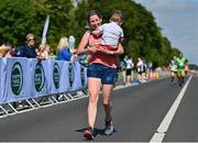 10 July 2022; Claire Lonergan, with her son Aaron, aged 2, from Firhouse in Dublin, celebrate finishing the Irish Runner 10 Mile, Sponsored by Sports Travel International, incorporating the AAI National 10 Mile Road Race Championships at the Phoenix Park in Dublin. Photo by Sam Barnes/Sportsfile