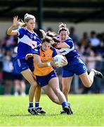 10 July 2022; Niamh O'Dea of Clare in action against Aisling Donoher, left, and Clodagh Dunne of Laois during the TG4 All-Ireland Ladies Football Intermediate Championship Semi-Final match between Clare and Laois at St Brigid’s GAA club in Kiltoom, Roscommon. Photo by David Fitzgerald/Sportsfile