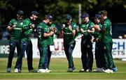 10 July 2022; Curtis Campher of Ireland, third from left, celebrates with teammates after claiming the wicket to New Zealand's Tom Latham, lbw, during the Men's One Day International match between Ireland and New Zealand at Malahide Cricket Club in Dublin. Photo by Seb Daly/Sportsfile