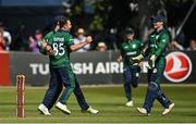 10 July 2022; Curtis Campher of Ireland, 35, celebrates with teammates after claiming the wicket of New Zealand's Henry Nicholls during the Men's One Day International match between Ireland and New Zealand at Malahide Cricket Club in Dublin. Photo by Seb Daly/Sportsfile