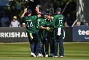 10 July 2022; Curtis Campher of Ireland, centre, celebrates with teammates after claiming the wicket of New Zealand's Henry Nicholls during the Men's One Day International match between Ireland and New Zealand at Malahide Cricket Club in Dublin. Photo by Seb Daly/Sportsfile