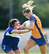 10 July 2022; Chloe Moloney of Clare in action against Clodagh Dunne of Laois during the TG4 All-Ireland Ladies Football Intermediate Championship Semi-Final match between Clare and Laois at St Brigid’s GAA club in Kiltoom, Roscommon. Photo by Brendan Moran/Sportsfile