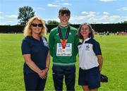 10 July 2022; Brid Golden, Vice President, Athletics Ireland, left, and Amanda Hynes, Juvenile Track and Field secretary, right, with Fintan Dewhirst of Ireland with his silver medal from the 400m hurdles at the European Under-18 Athletic Championships in Israel during day three of the Irish Life Health National Juvenile Track and Field Championships at Tullamore Harriers Stadium in Tullamore, Offaly. Photo by Diarmuid Greene/Sportsfile