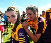 10 July 2022; Sarah Harding Kenny of Wexford signs an autograph for a young supporter after the TG4 All-Ireland Ladies Football Intermediate Championship Semi-Final match between Roscommon and Wexford at Crettyard GAA club, Crettyard, Laois. Photo by Michael P Ryan/Sportsfile