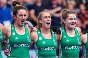 10 July 2022; Ireland players, from left, Hannah McLoughlin, Sarah Hawkshaw and Sarah Torrans sing the national anthem before the FIH Women's Hockey World Cup 9th/10th Place Play-off match between Ireland and South Africa at Wagener Stadium in Amstelveen, Netherlands. Photo by Jeroen Meuwsen/Sportsfile