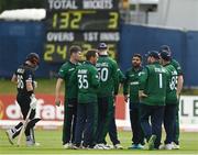 12 July 2022; Ireland players huddle as Henry Nicholls of New Zealand walks during the Men's One Day International match between Ireland and New Zealand at Malahide Cricket Club in Dublin. Photo by Harry Murphy/Sportsfile