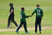 12 July 2022; Simi Singh of Ireland celebrates with teammate Harry Tector after taking the wicket on Tom Latham of New Zealand during the Men's One Day International match between Ireland and New Zealand at Malahide Cricket Club in Dublin. Photo by Harry Murphy/Sportsfile