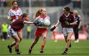 9 July 2022; Neveah Dowds, St. Brigid's P.S., Ballymena, Antrim, representing Derry, in action against Saoirse Murray, Craggagh N.S., Kiltimagh, Mayo, representing Galway, left, and Sian Bolger, St Brendans N.S., Muckalee, Kilkenny, representing Galway, during the INTO Cumann na mBunscol GAA Respect Exhibition Go Games match during half-time of the GAA Football All-Ireland Senior Championship Semi-Final match between Galway and Derry at Croke Park in Dublin. Photo by Seb Daly/Sportsfile
