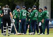 15 July 2022; Curtis Campher of Ireland, centre, is congratulated by teammates after running out Will Young of New Zealand during the Men's One Day International match between Ireland and New Zealand at Malahide Cricket Club in Dublin. Photo by Seb Daly/Sportsfile