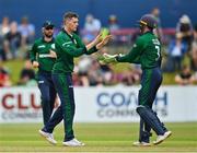 15 July 2022; Gareth Delany of Ireland, left, celebrates with teammate Lorcan Tucker after taking the wicket of New Zealand's Martin Guptill, lbw, during the Men's One Day International match between Ireland and New Zealand at Malahide Cricket Club in Dublin. Photo by Seb Daly/Sportsfile