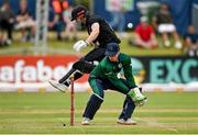 15 July 2022; Ireland wicketkeeper Lorcan Tucker and Henry Nicholls of New Zealand during the Men's One Day International match between Ireland and New Zealand at Malahide Cricket Club in Dublin. Photo by Seb Daly/Sportsfile