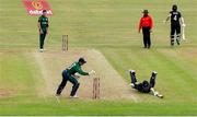 15 July 2022; Ireland wicketkeeper Lorcan Tucker attempts to run out Mitchell Santner of New Zealand during the Men's One Day International match between Ireland and New Zealand at Malahide Cricket Club in Dublin. Photo by Seb Daly/Sportsfile