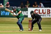 15 July 2022; Paul Stirling of Ireland plays a shot, watched by New Zealand wicketkeeper Tom Latham, during the Men's One Day International match between Ireland and New Zealand at Malahide Cricket Club in Dublin. Photo by Seb Daly/Sportsfile
