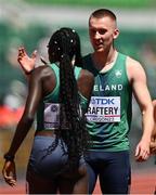 15 July 2022; Jack Raftery of Ireland, right, celebrates with team-mate Rhasidat Adeleke of Ireland  after  finishing second in the mixed 4x400m relay heats during day one of the World Athletics Championships at Hayward Field in Eugene, Oregon, USA. Photo by Sam Barnes/Sportsfile