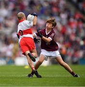 9 July 2022; Fionn Rea, Primate Dixon Coalisland, Coalisland, Tyrone, representing Derry is tackled by George Morrison, Bunscoil Bhóthar na Naomh, Lismore, Port Láirge, representing Galway during the INTO Cumann na mBunscol GAA Respect Exhibition Go Games at half-time of the GAA Football All-Ireland Senior Championship Semi-Final match between Galway and Derry at Croke Park in Dublin. Photo by Ray McManus/Sportsfile
