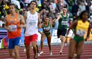 15 July 2022; Sharlene Mawdsley of Ireland takes the baton from teammate Jack Raftery in the 4x400m mixed relay final during day one of the World Athletics Championships at Hayward Field in Eugene, Oregon, USA. Photo by Sam Barnes/Sportsfile