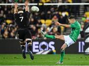 16 July 2022; Jonathan Sexton of Ireland kicks under pressure from Sam Cane of New Zealand during the Steinlager Series match between the New Zealand and Ireland at Sky Stadium in Wellington, New Zealand. Photo by Brendan Moran/Sportsfile