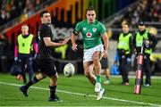 16 July 2022; James Lowe of Ireland kicks under pressure from Will Jordan of New Zealand during the Steinlager Series match between the New Zealand and Ireland at Sky Stadium in Wellington, New Zealand. Photo by Brendan Moran/Sportsfile