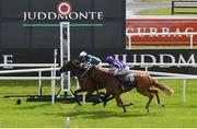 16 July 2022; Magical Lagoon, left, with Shane Foley up, crosses the line to win the Juddmonte Irish Oaks, from second place Toy, right, with Ryan Moore up, during day one of the Juddmonte Irish Oaks Weekend at The Curragh Racecourse in Kildare. Photo by Seb Daly/Sportsfile