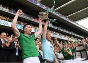 17 July 2022; An Taoiseach Mícheál Martin TD looks on as Declan Hannon, left, and Cian Lynch of Limerick lift the Liam MacCarthy Cup after the GAA Hurling All-Ireland Senior Championship Final match between Kilkenny and Limerick at Croke Park in Dublin. Photo by Ray McManus/Sportsfile