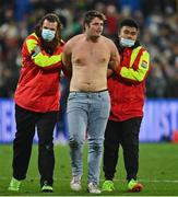 16 July 2022; A pitch invader is escorted from the pitch by stewards during the Steinlager Series match between the New Zealand and Ireland at Sky Stadium in Wellington, New Zealand. Photo by Brendan Moran/Sportsfile