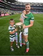 17 July 2022; Charlie Carey, left, and Limerick's Séamus Flanagan and his 12-week-old son Freddie celebrate with the Liam MacCarthy Cup after the GAA Hurling All-Ireland Senior Championship Final match between Kilkenny and Limerick at Croke Park in Dublin. Photo by Stephen McCarthy/Sportsfile