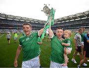 17 July 2022; Limerick's David Reidy, left, and Graeme Mulcahy with his one-year-old daughter Róise celebrate with the Liam MacCarthy Cup after the GAA Hurling All-Ireland Senior Championship Final match between Kilkenny and Limerick at Croke Park in Dublin. Photo by Stephen McCarthy/Sportsfile