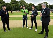 20 July 2022; Ireland captain Andrew Balbirnie tosses the coin, alongside New Zealand captain Mitchell Santner, match referee Kevin Gallagher, right, and Presenter Craig McMillan before the Men's T20 International match between Ireland and New Zealand at Stormont in Belfast. Photo by Seb Daly/Sportsfile