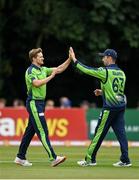 20 July 2022; Barry McCarthy of Ireland, left, celebrates with teammate Andrew Balbirnie after claiming the wicket of New Zealand's Martin Guptill during the Men's T20 International match between Ireland and New Zealand at Stormont in Belfast. Photo by Seb Daly/Sportsfile