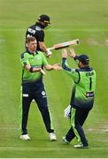20 July 2022; Craig Young of Ireland, left, celebrates with teammate Paul Stirling after claiming the wicket of New Zealand's Glenn Phillips during the Men's T20 International match between Ireland and New Zealand at Stormont in Belfast. Photo by Seb Daly/Sportsfile