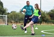 21 July 2022; Republic of Ireland U21s Manager Jim Crawford and participant Sarah Blake during his visit to the Football For All Summer Soccer School at St Patrick's Boys AFC in Carlow. Photo by Seb Daly/Sportsfile