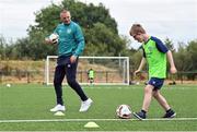 21 July 2022; Republic of Ireland U21s Manager Jim Crawford with participant Conor Blake during his visit to the Football For All Summer Soccer School at St Patrick's Boys AFC in Carlow. Photo by Seb Daly/Sportsfile