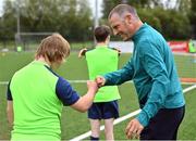 21 July 2022; Republic of Ireland U21s Manager Jim Crawford with participant Zac Feeney during the Football For All Summer Soccer School at St Patrick's Boys AFC in Carlow. Photo by Seb Daly/Sportsfile