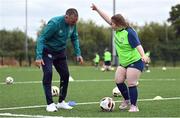21 July 2022; Republic of Ireland U21s Manager Jim Crawford with participant Ava Crampton during his visit to the Football For All Summer Soccer School at St Patrick's Boys AFC in Carlow. Photo by Seb Daly/Sportsfile