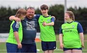 21 July 2022; Coach Niall Lyons with participants, from left, Zac Feeney, Jake Malone, and Ava Crampton during the Football For All Summer Soccer School at St Patrick's Boys AFC in Carlow. Photo by Seb Daly/Sportsfile
