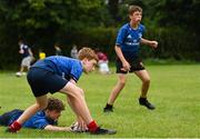 21 July 2022; Christian Shortall, centre, passes  with Finn Clarke during the Bank of Ireland Leinster Rugby School of Excellence at The King's Hospital School in Dublin. Photo by Harry Murphy/Sportsfile