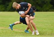 21 July 2022; Billy Cross is tackled by Neil Machiels during the Bank of Ireland Leinster Rugby School of Excellence at The King's Hospital School in Dublin. Photo by Harry Murphy/Sportsfile