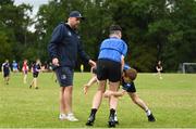 21 July 2022; Eddie Darcy is tackled by Conor Mulligan watched by coach Duane Moss during the Bank of Ireland Leinster Rugby School of Excellence at The King's Hospital School in Dublin. Photo by Harry Murphy/Sportsfile