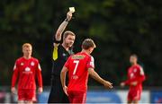 22 July 2022; Referee John McLoughlin shows a yellow card to Brian McManus of Shelbourne during the SSE Airtricity League Premier Division match between UCD and Shelbourne at the UCD Bowl in Belfield, Dublin. Photo by Seb Daly/Sportsfile