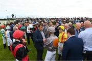 26 July 2022; Trainer Adrian McGuinness speaks to his jockeys before the Colm Quinn BMW Mile Handicap during day two of the Galway Races Summer Festival at Ballybrit Racecourse in Galway. Photo by Harry Murphy/Sportsfile