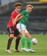 25 July 2022; Lewis Trickett of Northern Ireland in action against Sam Murray of Manchester United during the SuperCupNI match between Northern Ireland and Manchester United at Coleraine Showgrounds in Coleraine, Derry. Photo by Ramsey Cardy/Sportsfile